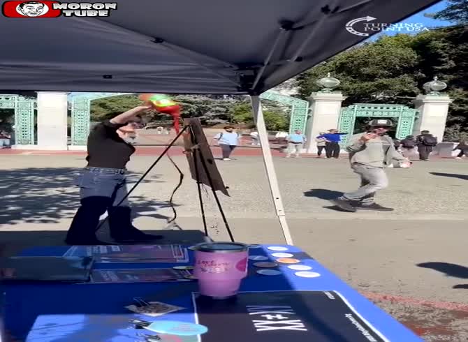Video :Tomato juice is thrown at the Republican booth by a left-wing protester